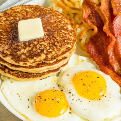 plate of pancakes, eggs and bacon