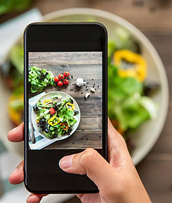 Smartphone taking a picture of a salad