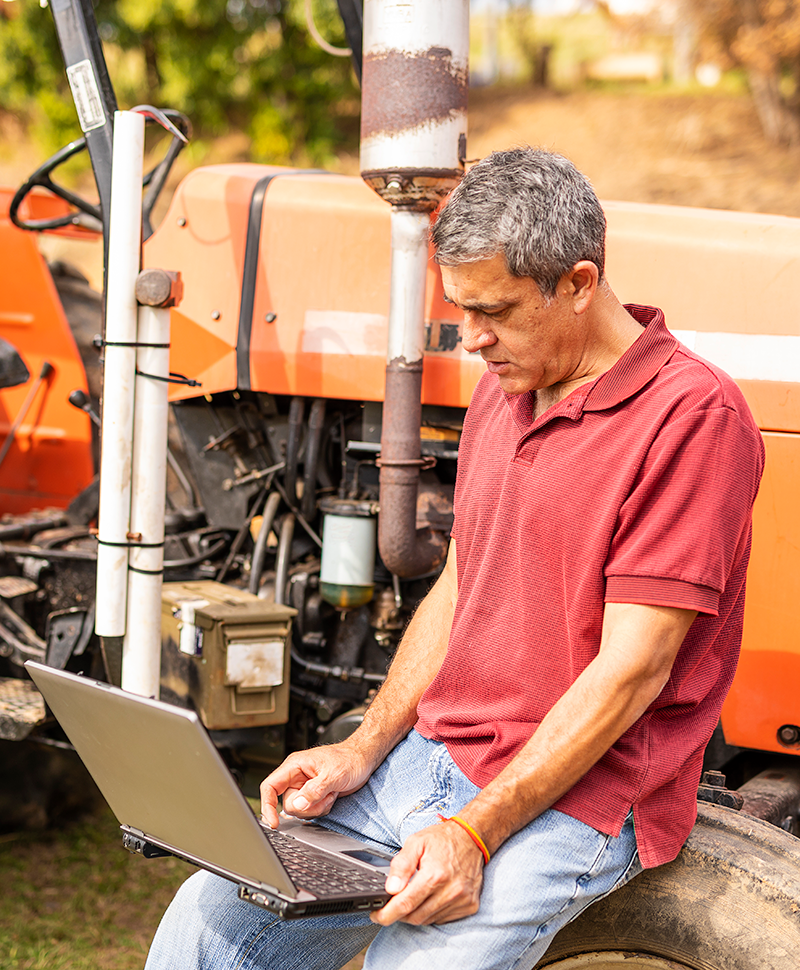 Man using a laptop on a farm
