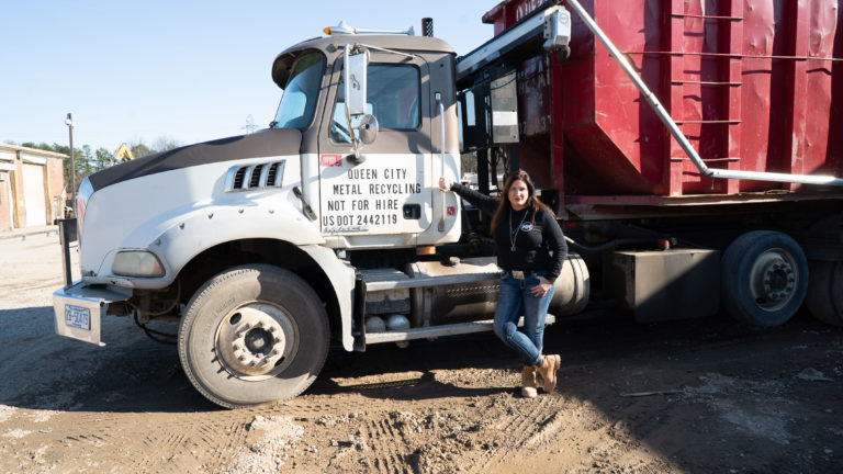 Woman standing with a big truck