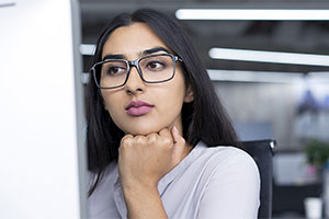 Woman looking at desktop computer screen