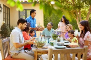 Hispanic family dining outdoors